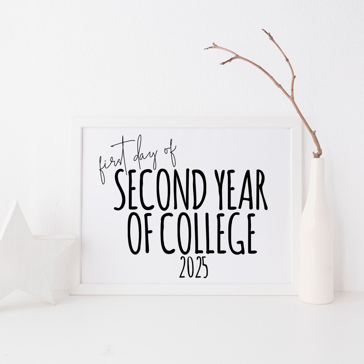 White board with 'first day of second year of college 2025' text on a white background with a branch decoration.