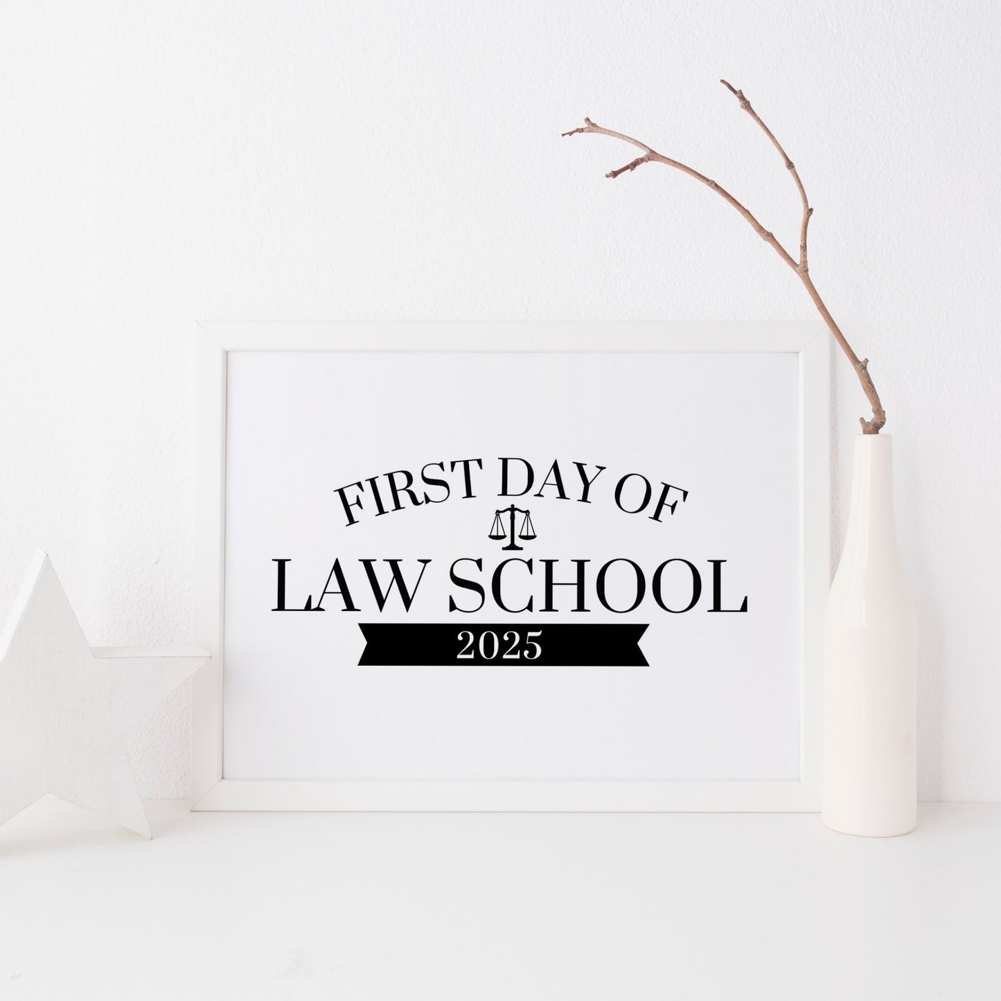 Framed sign for the 'First Day of Law School 2025' on a white background with a branch decoration.