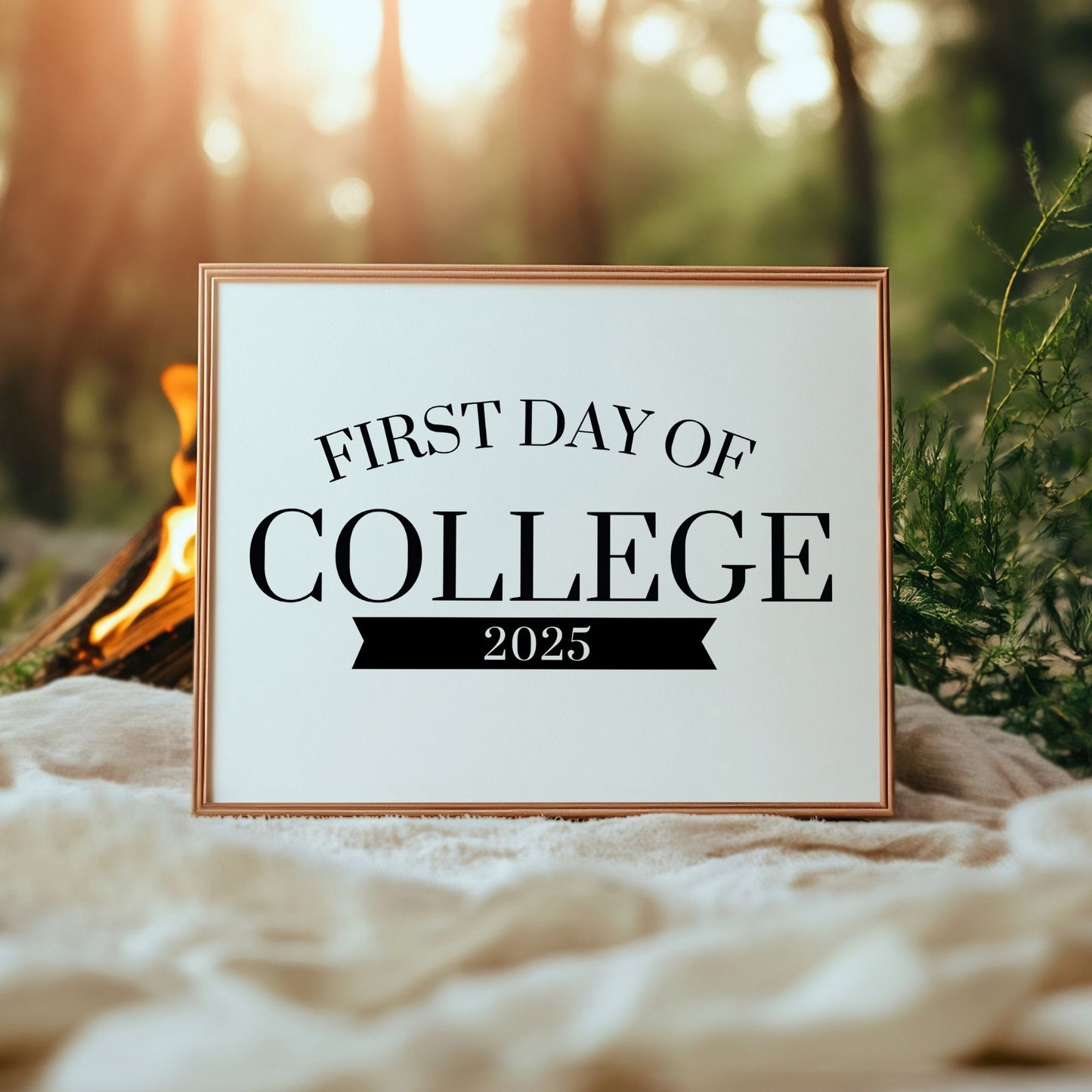 Framed sign with 'First Day of College 2025' text against a natural background with a campfire.