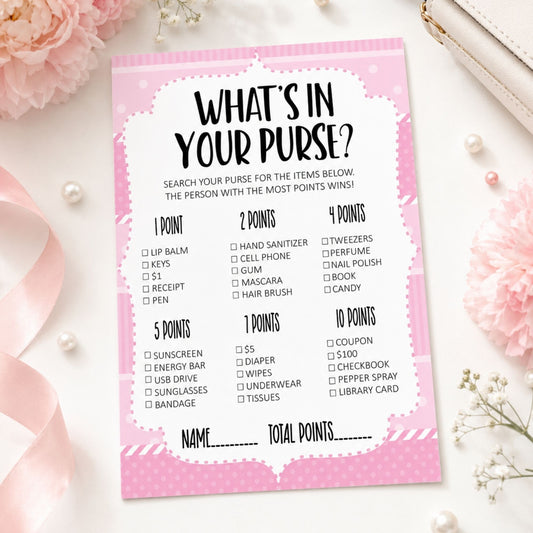 A pink and white 'What's in Your Purse?' party game score card styled in a flat-lay with pink flowers, pearls, and a white leather strap.