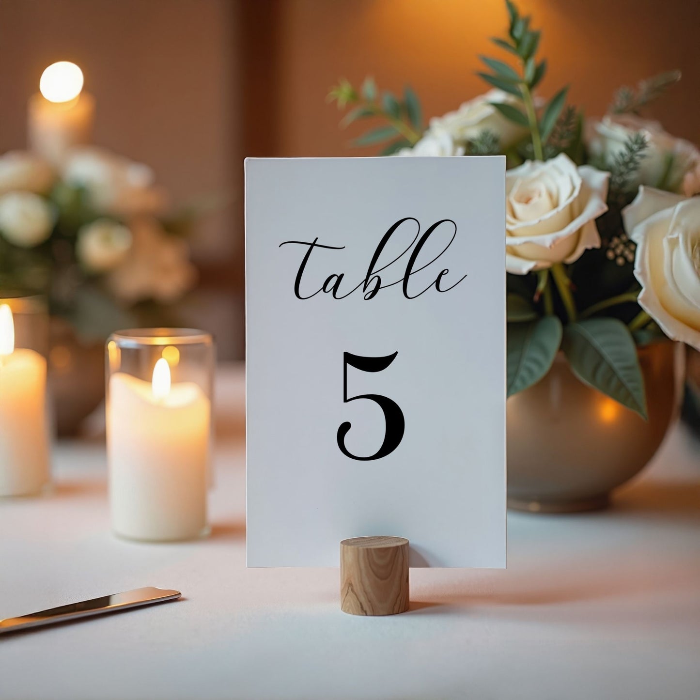Table number 5 card on a table with candles and flowers