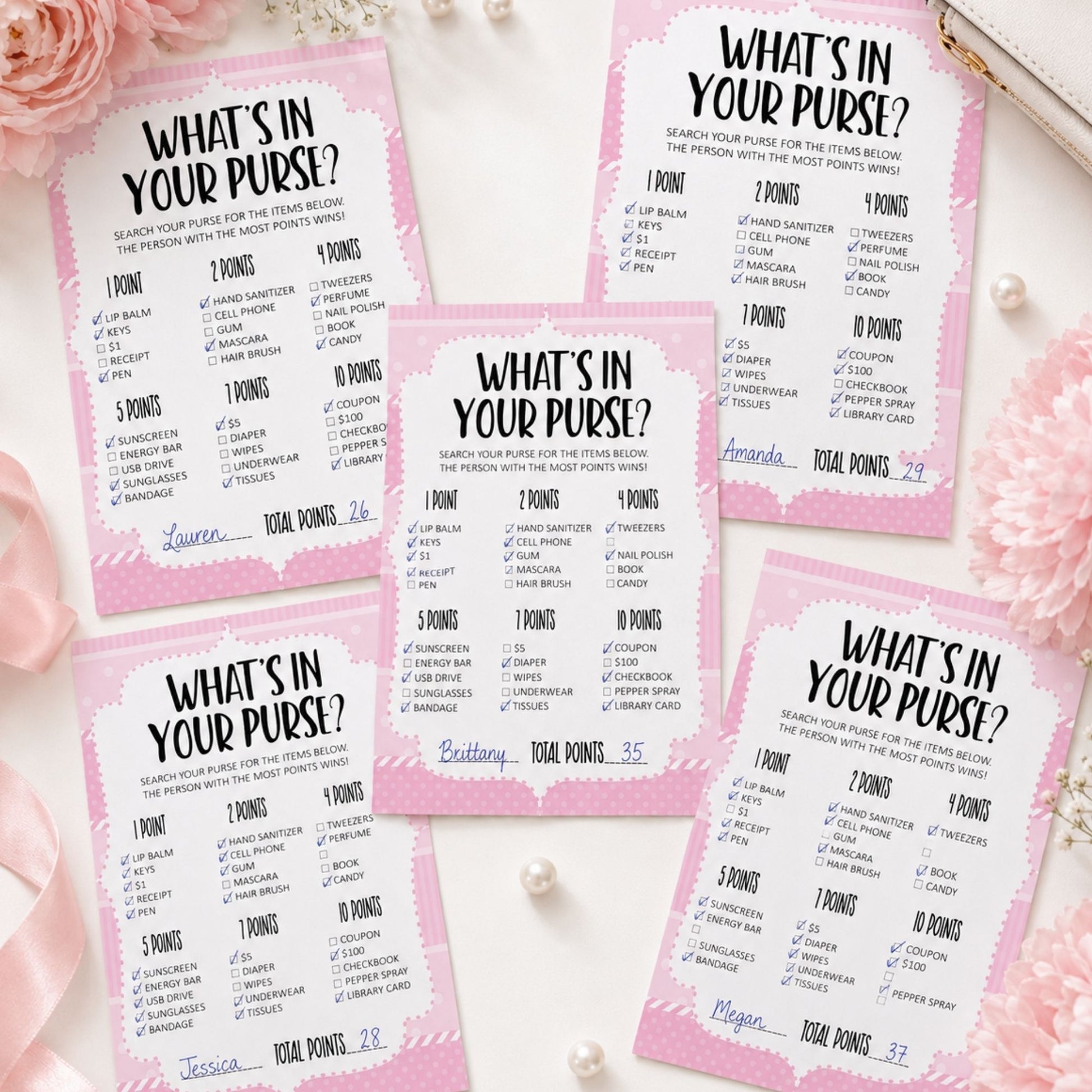 Five pink and white 'What's in your purse?' game cards arranged on a white surface with pink roses and pearl beads.