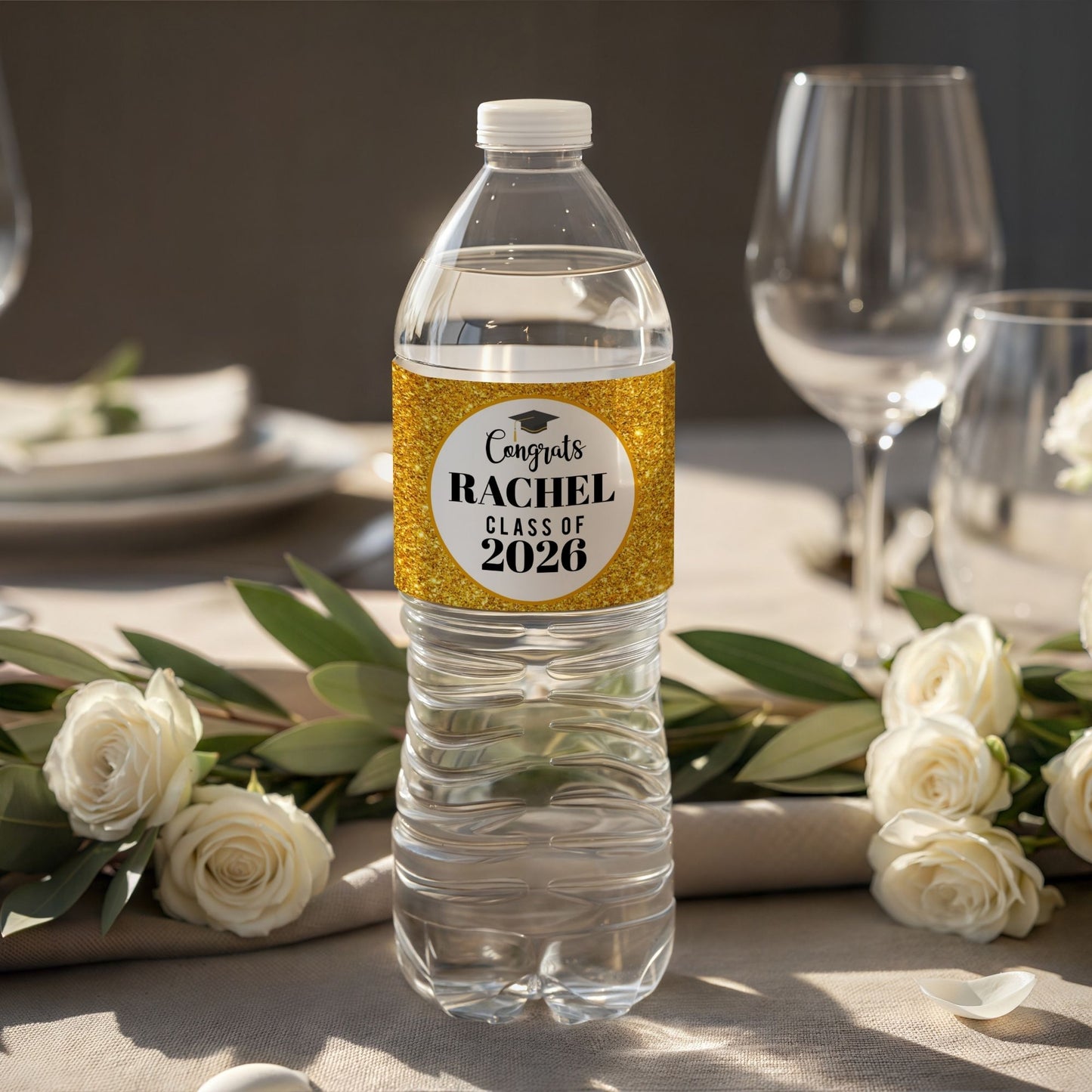 Water bottle with a personalized label on a table setting with flowers and glasses