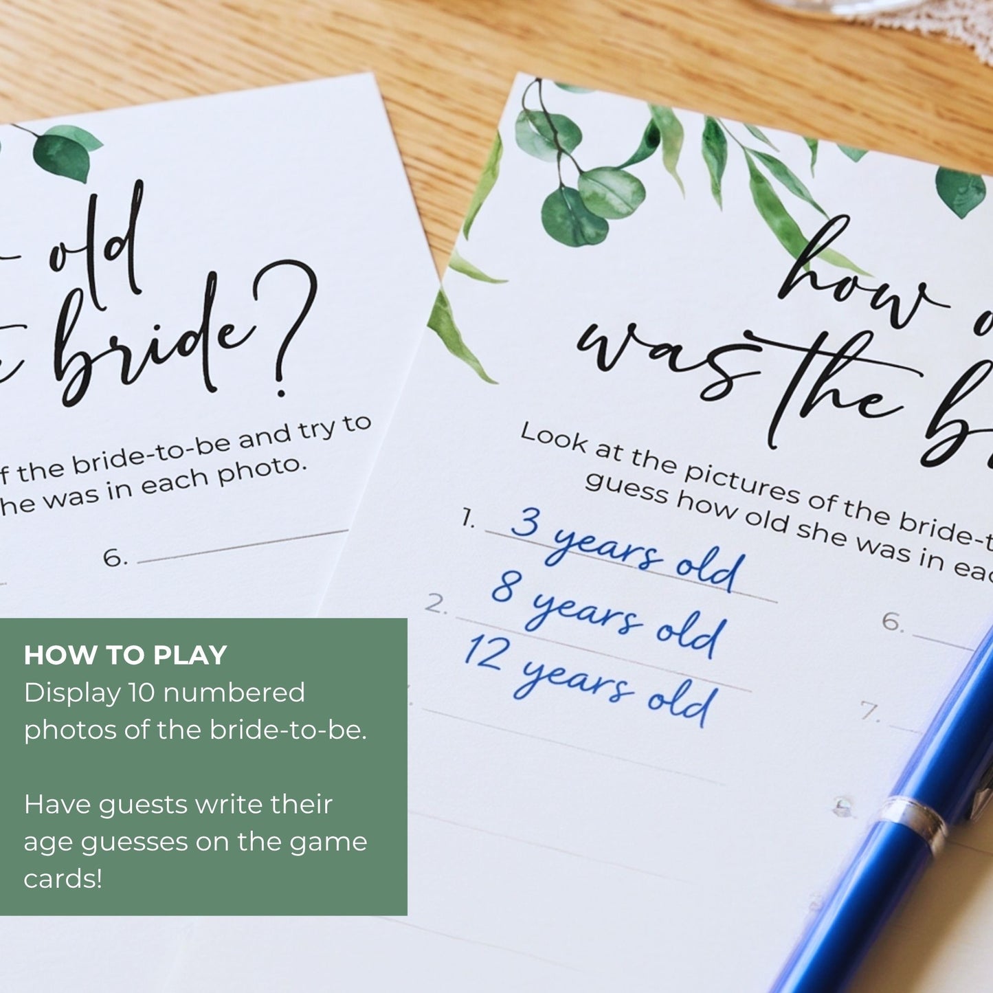 Bride-to-be age guessing game cards with a pen on a wooden surface