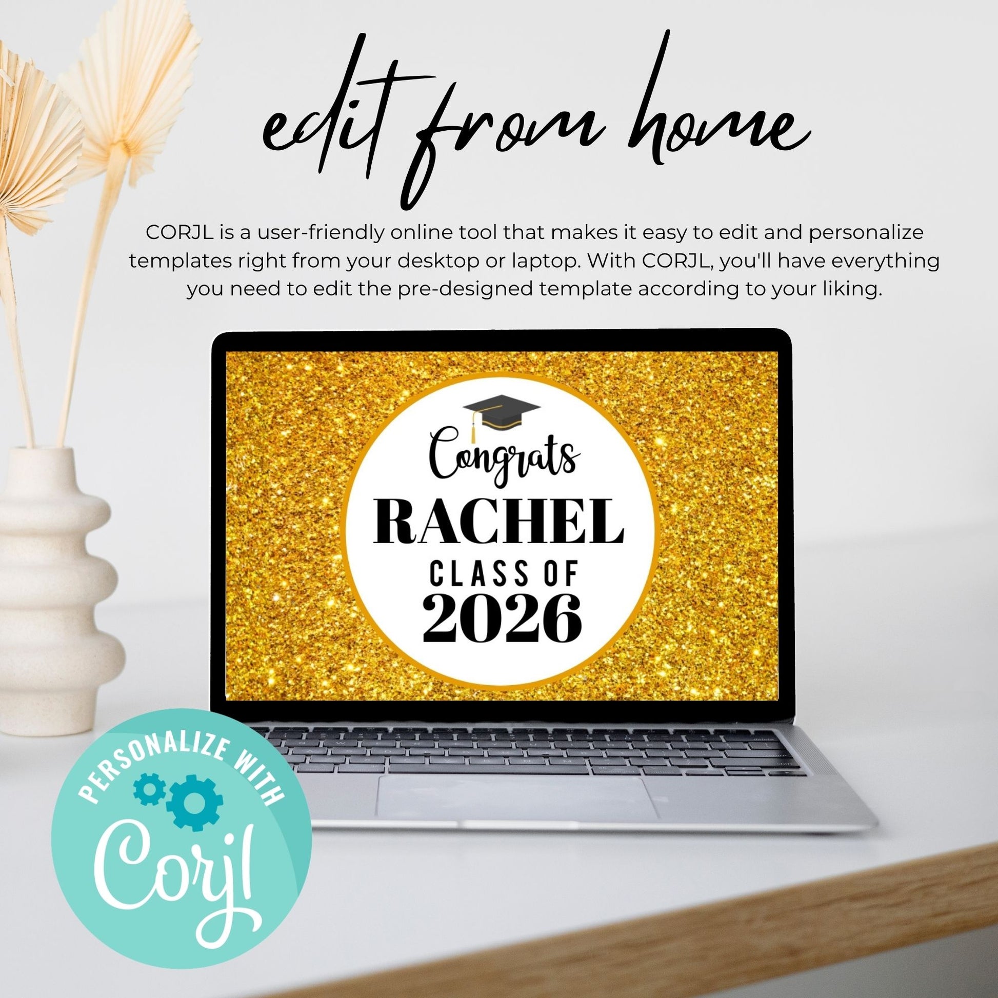 Laptop with graduation-themed screen on a white surface with decorative elements.