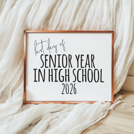 Framed sign with 'last day of senior year in high school 2026' text on a soft fabric background