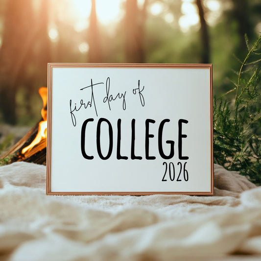 Framed sign with 'first day of college 2026' text against a natural background