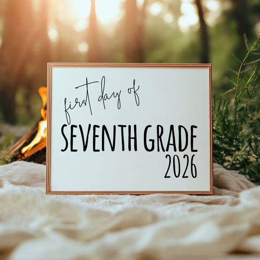Framed sign with 'first day of Seventh Grade 2026' text against a natural background.