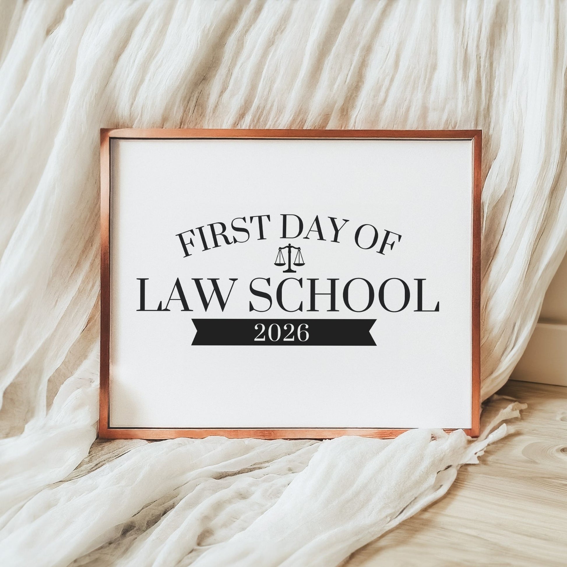 Framed sign for the 'First Day of Law School 2026' on a soft fabric background