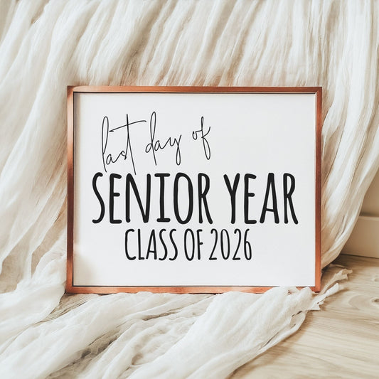 Framed sign with 'Last day of Senior Year Class of 2026' text on a soft fabric background