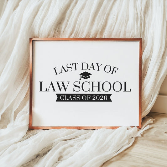 Framed sign with 'Last Day of Law School Class of 2026' text on a soft fabric background