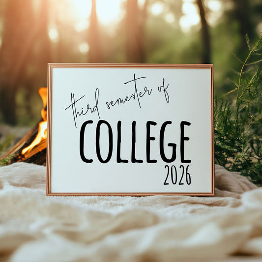 Framed sign with 'third semester of college 2026' text against a natural background
