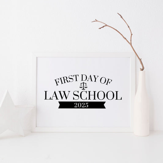Framed sign for the 'First Day of Law School 2025' on a white background with a branch decoration.
