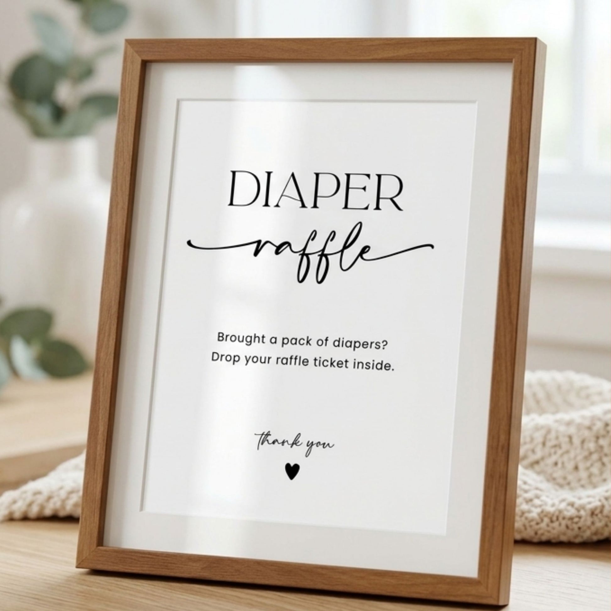 Framed poster with 'Diaper raffle' text on a light background