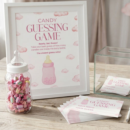 Baby shower candy guessing game kit with a white-framed sign reading 'Candy Guessing Game,' a clear baby bottle filled with pink and multicolored candies, a clear gift box, and printed ticket slips on a wooden surface.