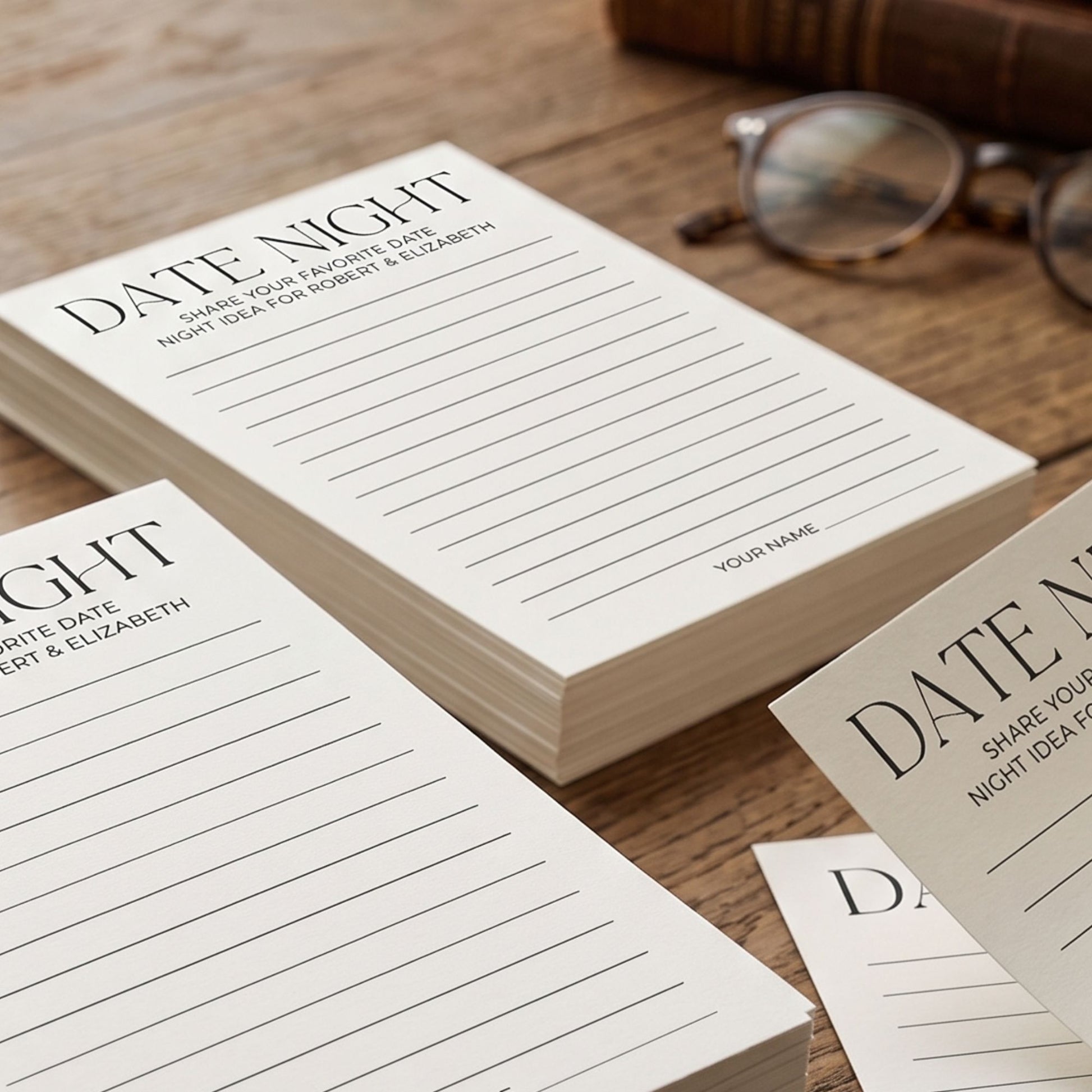 Stack of printable date night idea cards for bridal shower guests featuring minimalist black typography, lined writing space, and personalized couple names.