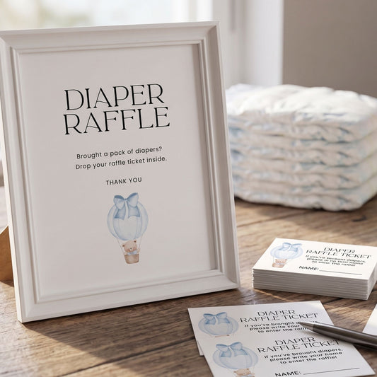 Framed diaper raffle sign with raffle tickets on a wooden surface