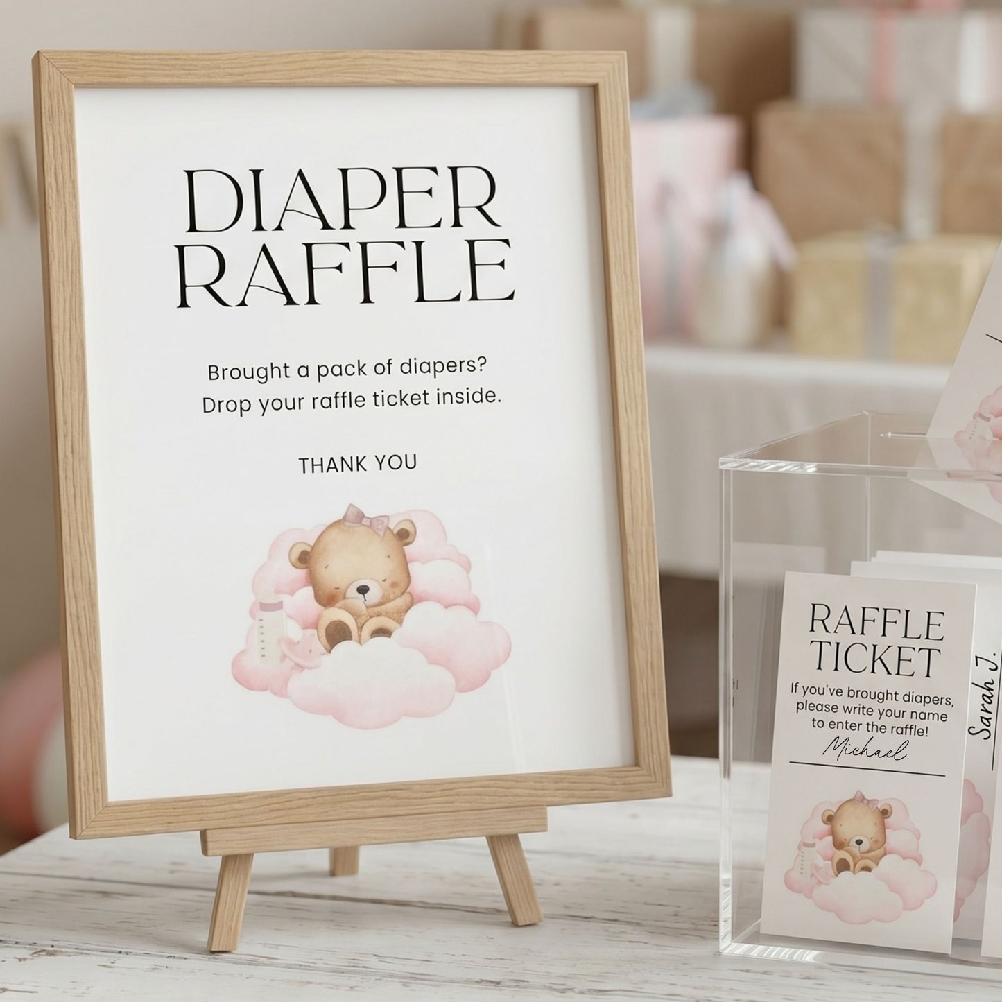 Diaper raffle sign with teddy bear illustration and raffle ticket holder at a baby shower.