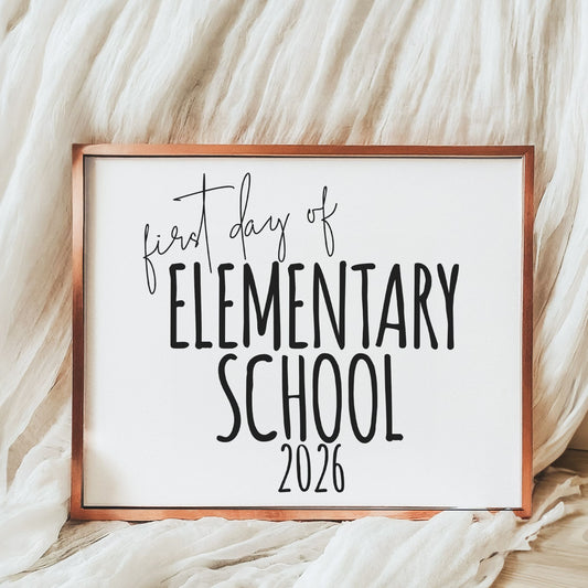 Framed sign with 'first day of Elementary School 2026' text on a soft fabric background