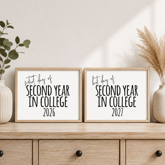 Two framed prints with graduation-themed text, displayed side by side on a wooden cabinet with decorative plants and vases in a styled interior setting.