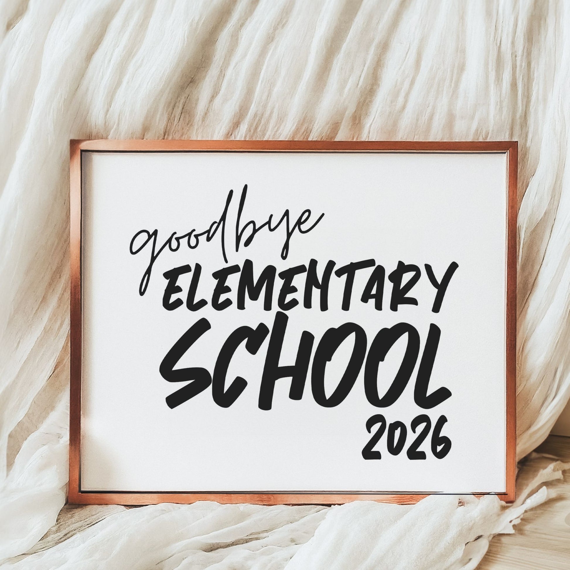Framed sign with 'goodbye elementary school 2026' text on a soft, white background