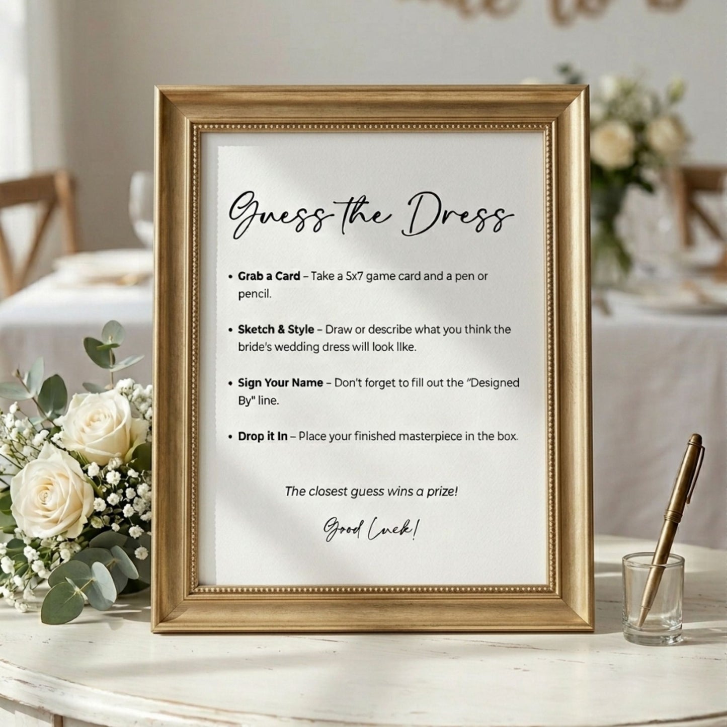Framed 'Guess the Dress' game instructions on a table with flowers and a pen.