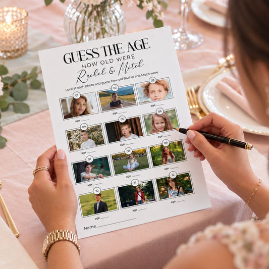 A person holds a printed 'Guess the Age' activity sheet featuring photos of a couple, Rachel and Mitch, with age labels, while writing on it with a black pen at a styled dining table.