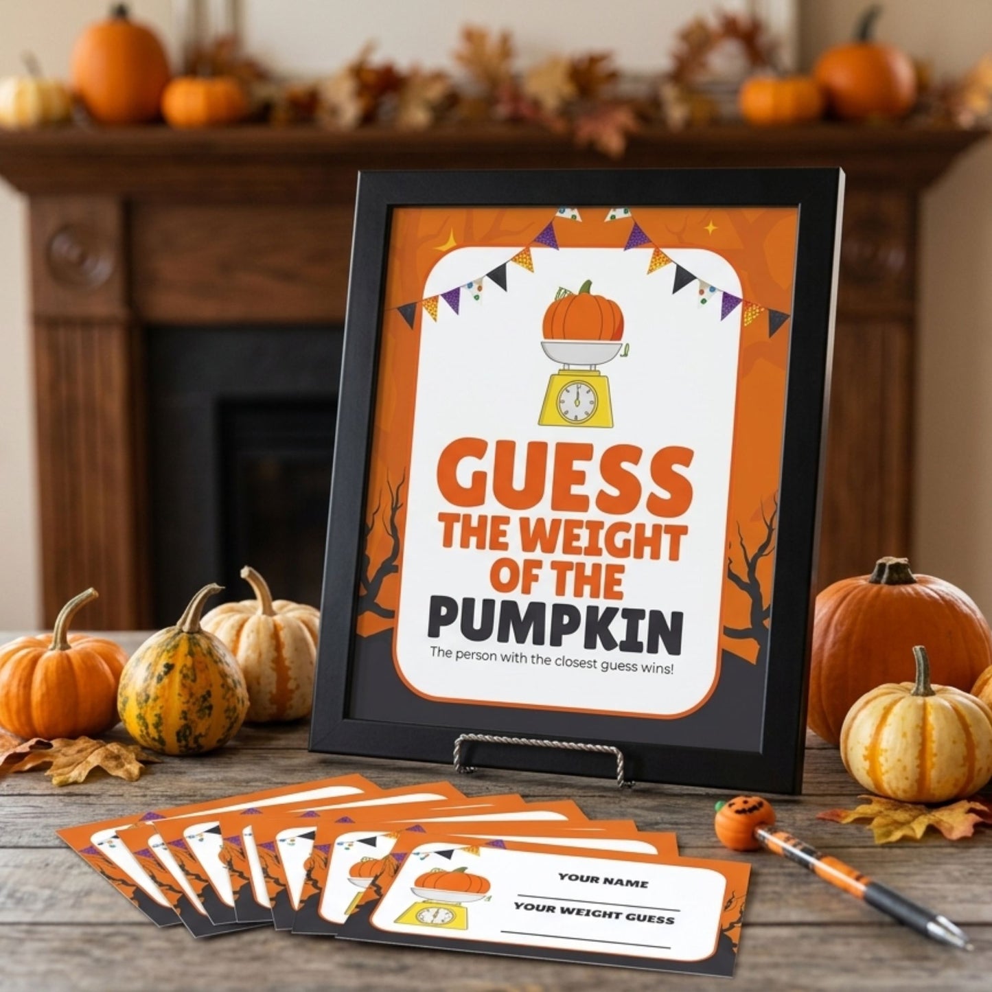 A framed Halloween party game card reading 'GUESS THE WEIGHT OF THE PUMPKIN' is displayed on a tabletop in a fall-themed setting with pumpkins, leaves, and a fireplace. Several matching game cards and a small pumpkin prop are arranged in front.