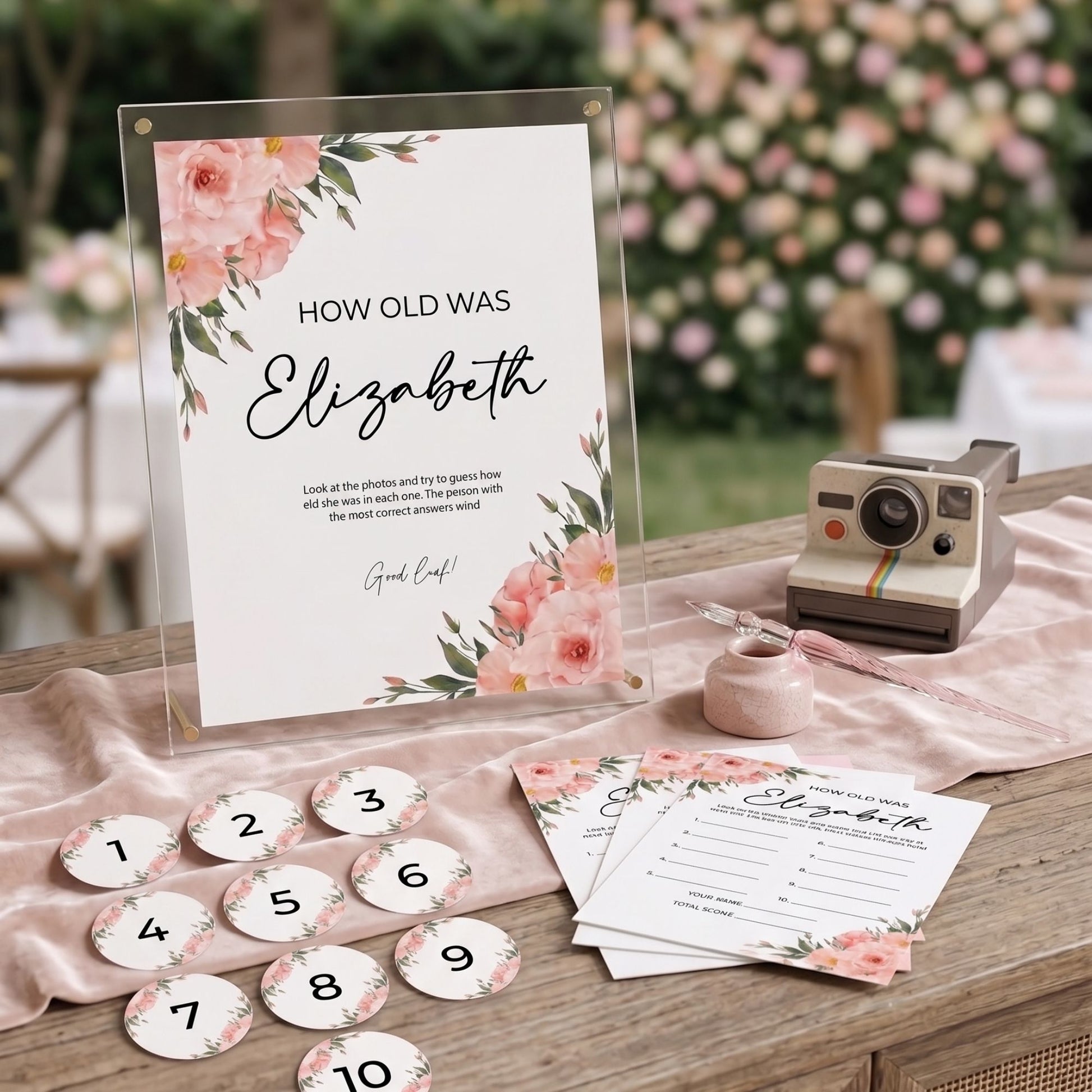 Decorative table setting with a 'How old was Elizabeth' game on a wooden table.