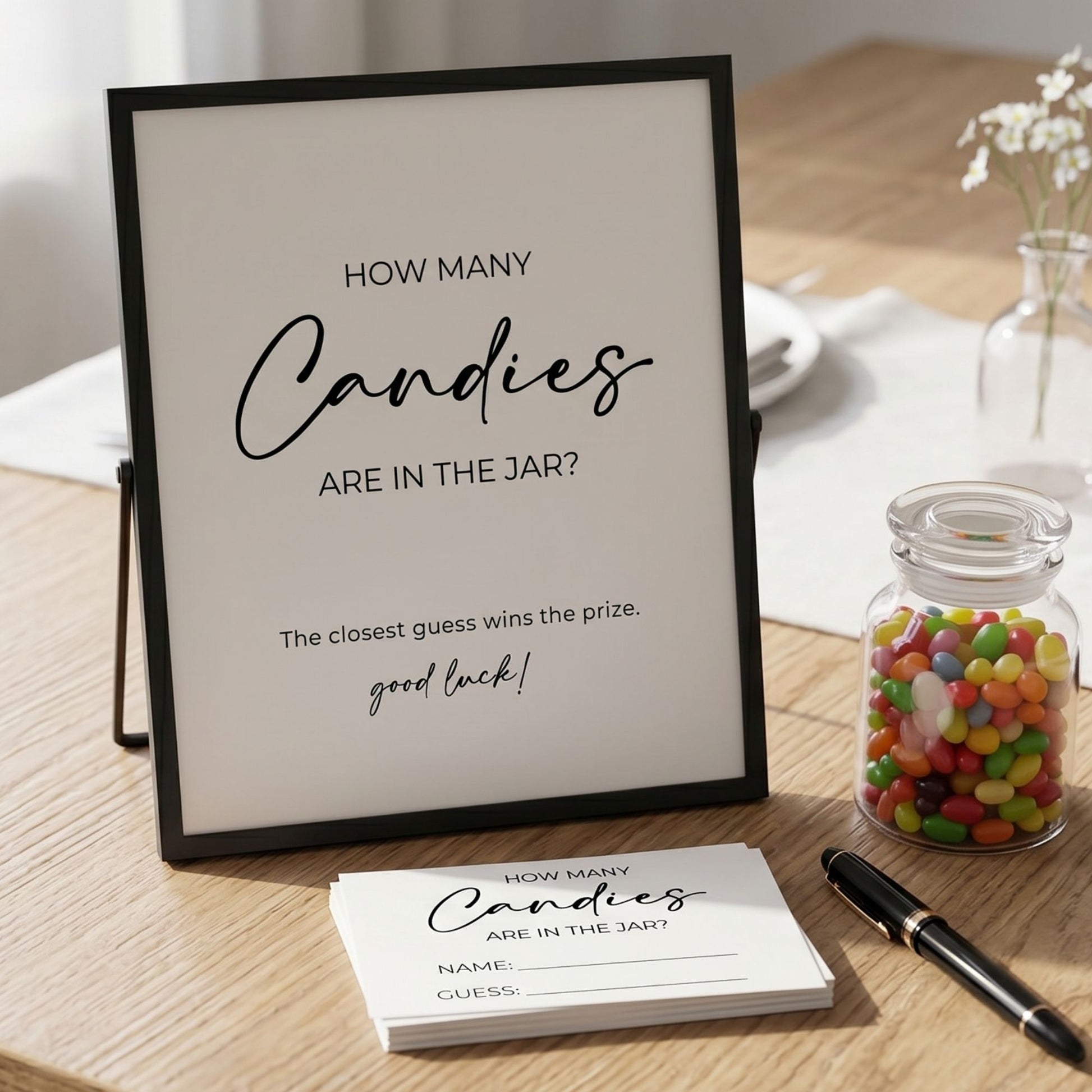Game of 'How Many Candies Are in the Jar?' with a framed question, card, pen, and jar of candies on a table.