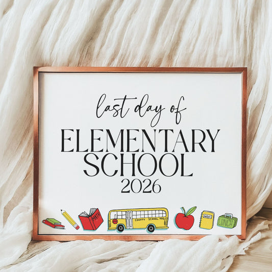 Framed sign with 'Last Day of Elementary School 2026' text on a soft fabric background