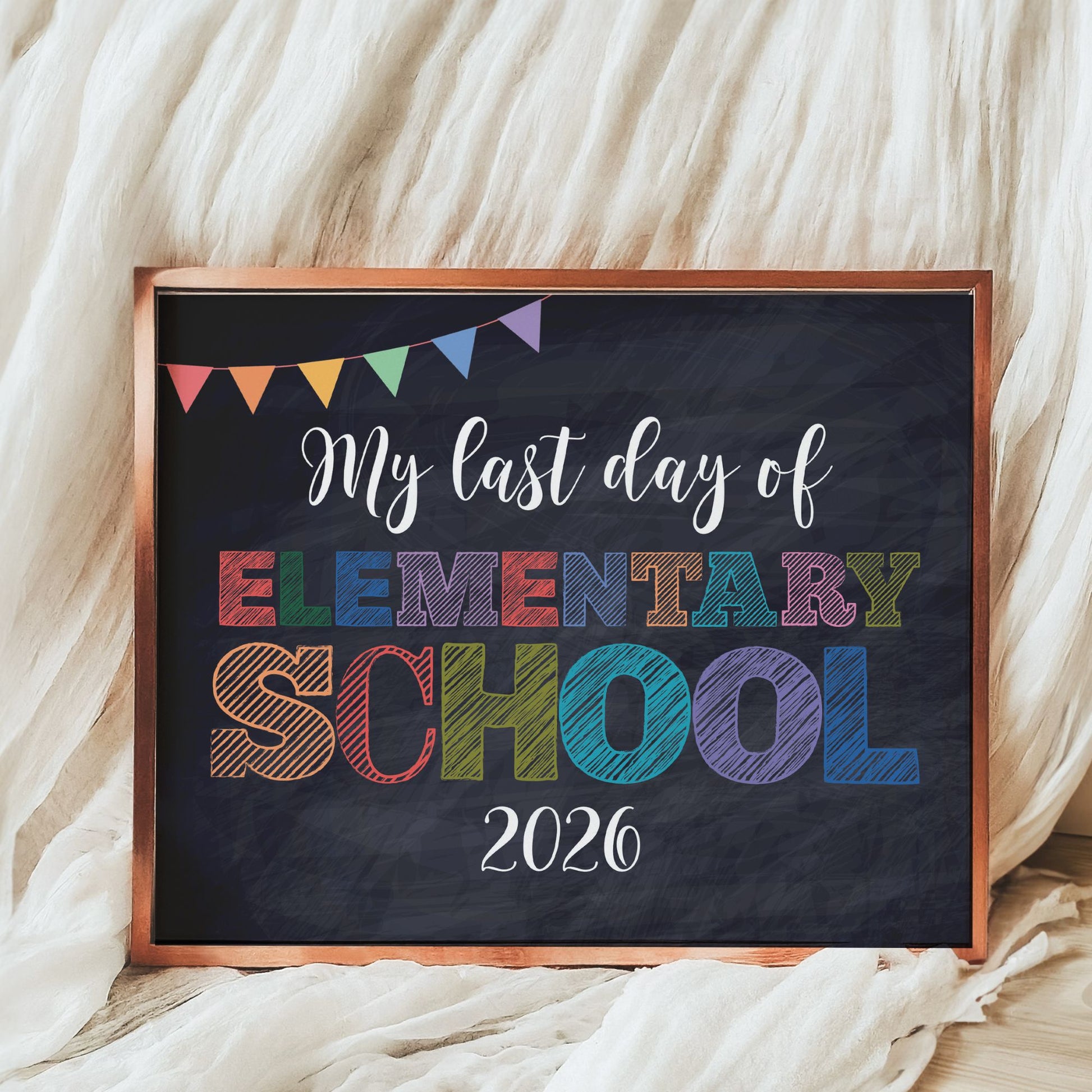 Decorative sign with 'My last day of Elementary School 2026' text on a blackboard background.