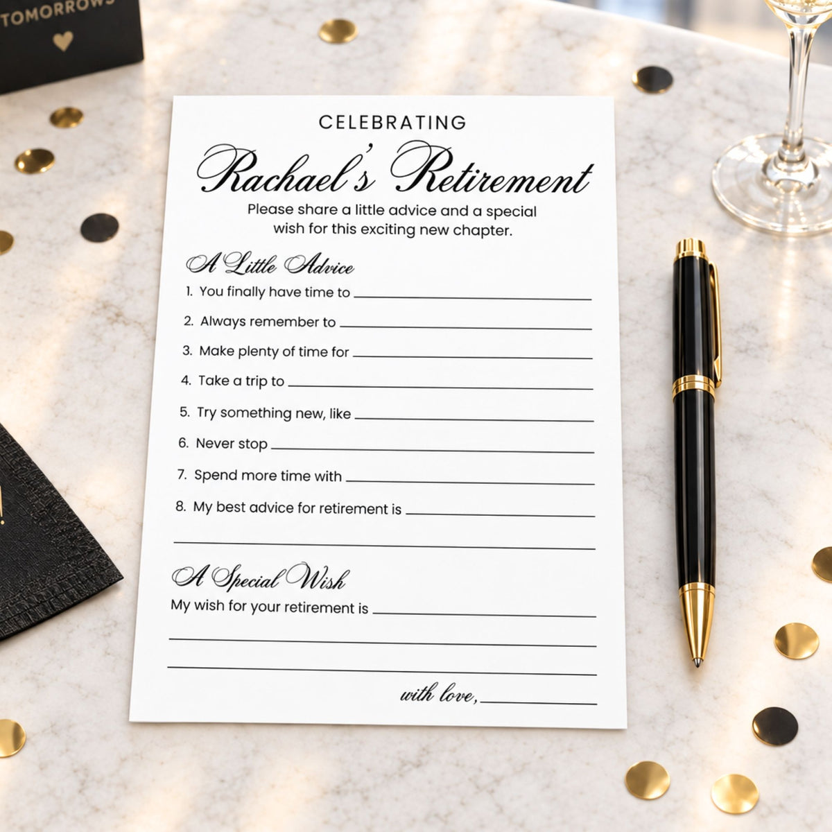 A printed retirement gift sign or card reading 'Celebrating Rachael's Retirement' with fill-in lines, styled on a marble surface with a black pen, gold confetti, a glass, and a black textured item nearby.