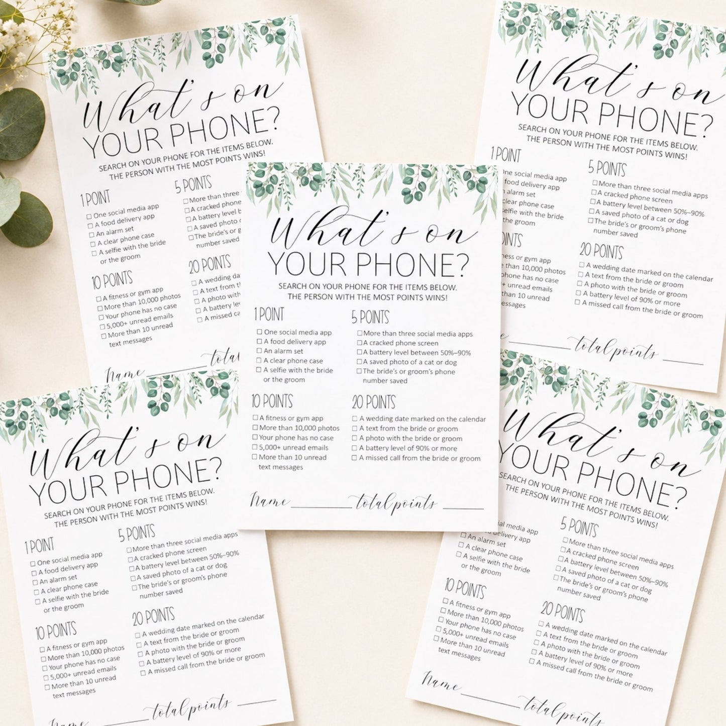 Four printed party game cards titled "What son YOUR PHONE?" arranged on a light neutral background with decorative botanical borders. The cards show scoring sections, checkboxes, and fill-in lines, with a small green leaf prop at the upper left.