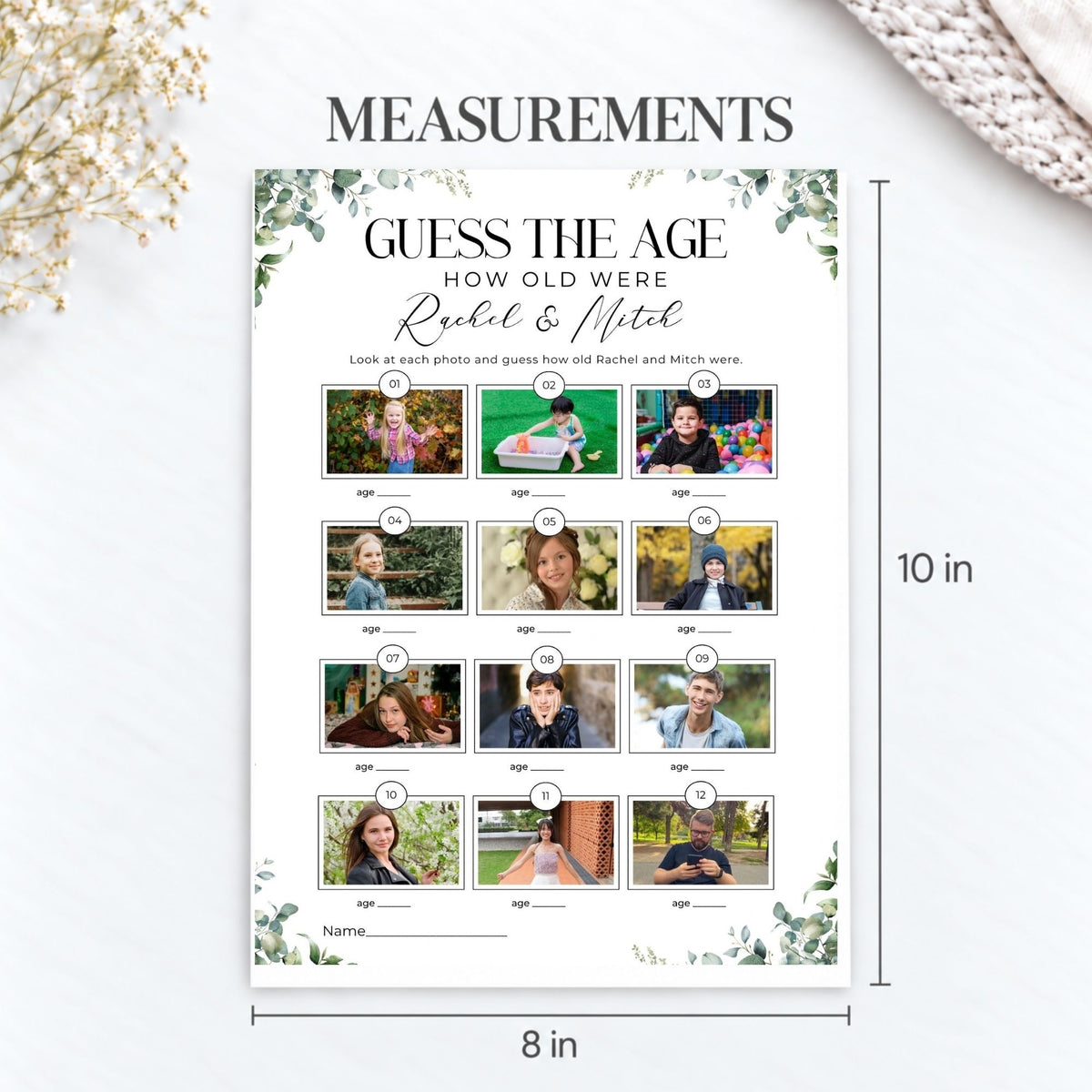 A personalized age-guessing game card shown on a light background with decorative dried flowers and a knit fabric corner. The card reads 'GUESS THE AGE How old were Rachel & Mitch' with 12 small photo placeholders, age lines, and dimensions marked 10 in tall and 8 in wide.
