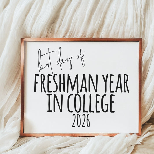 Sign with 'last day of freshman year in college 2026' text on a soft fabric background